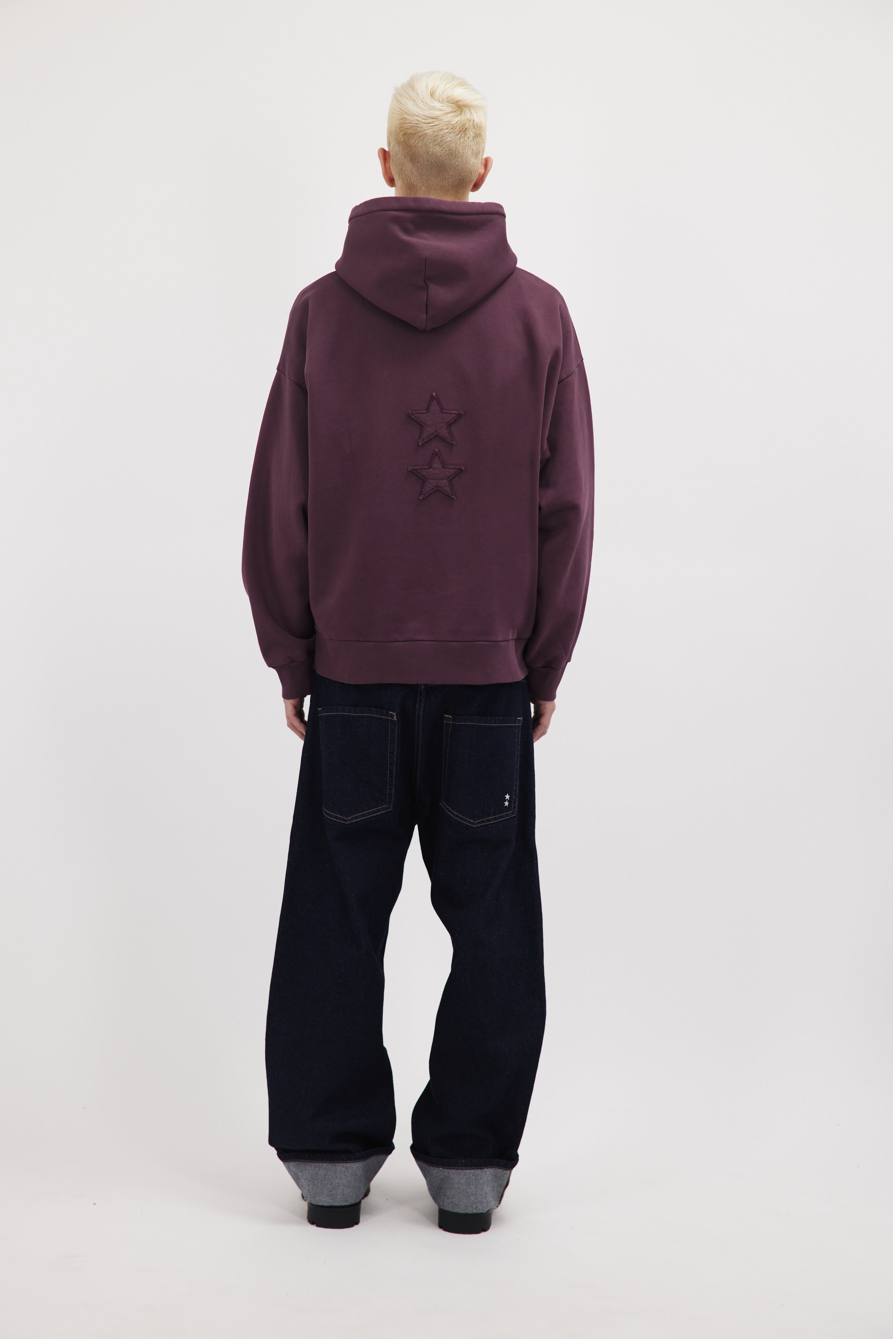 Back view of Owen men’s hoodie in cherry, 100% cotton, worn by a model.