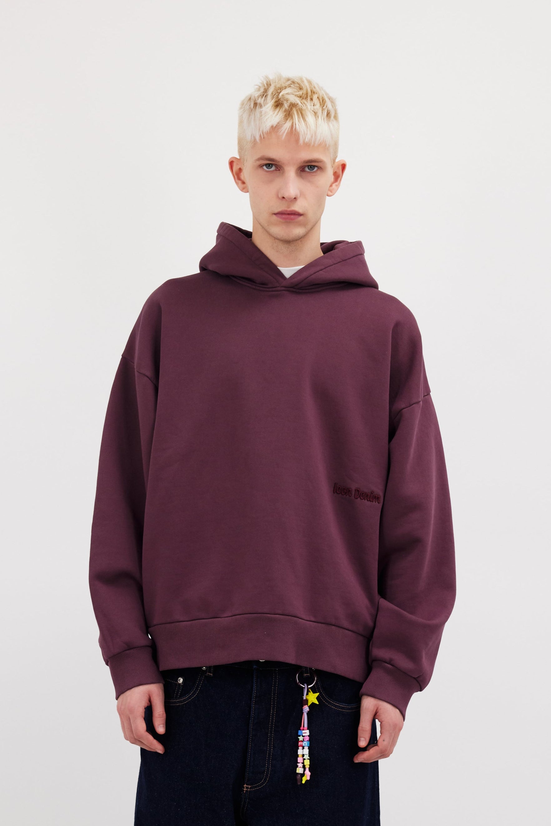 Owen men’s hoodie in cherry, 100% cotton, worn by a model.