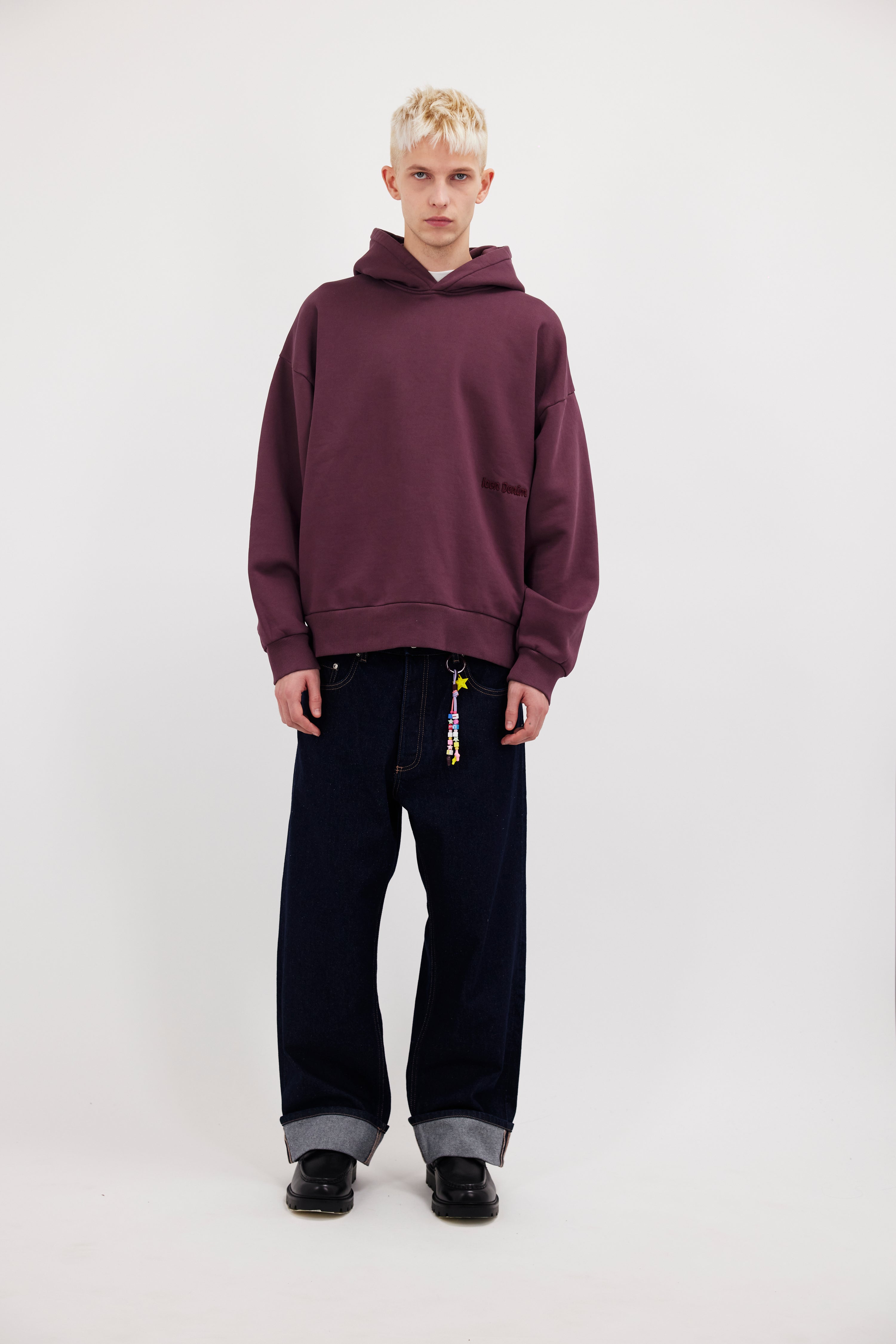Owen men’s hoodie in cherry, 100% cotton, worn by a model.