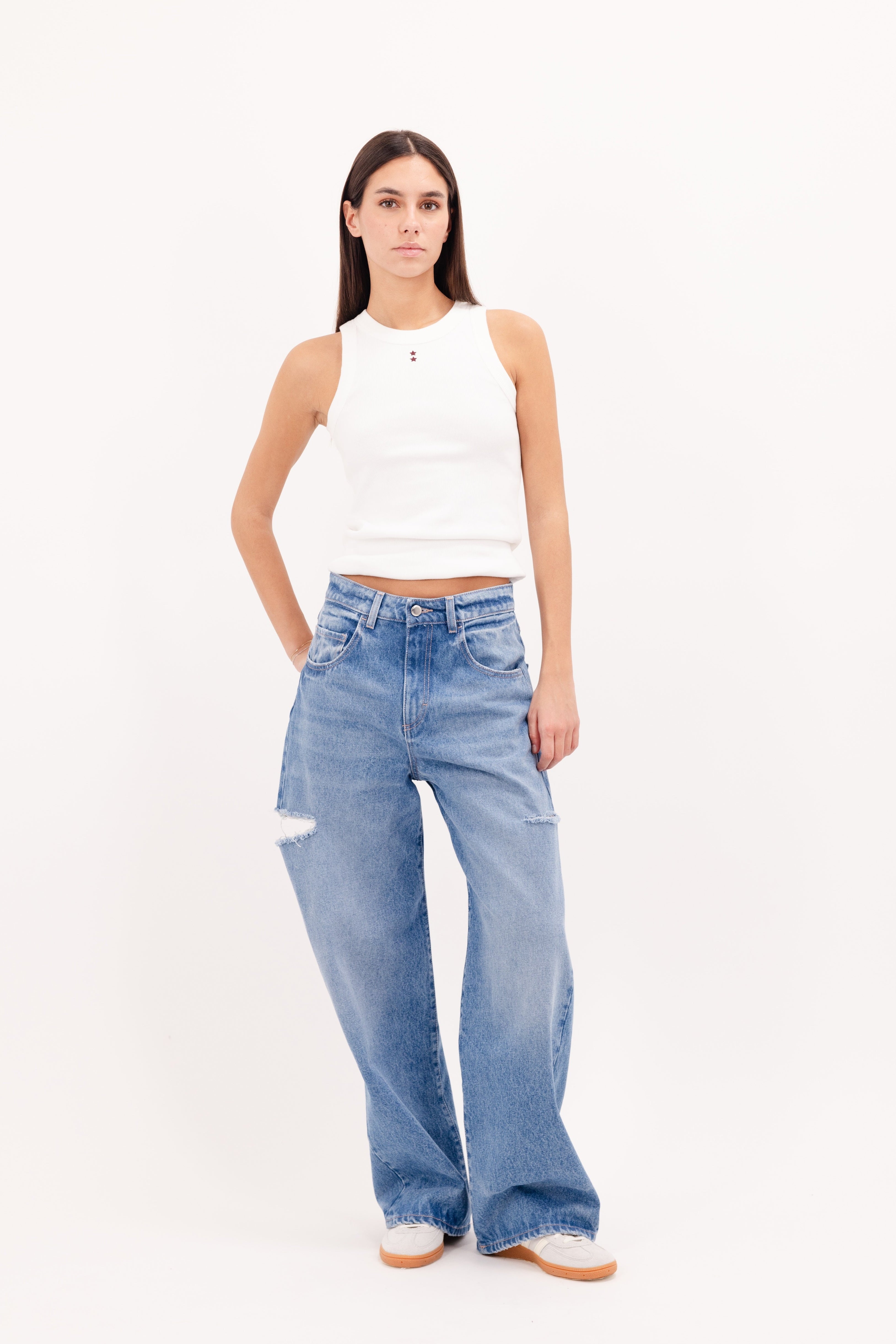 Poppy women’s wide leg jeans in deep ocean wash, 100% rigid organic cotton denim, worn by a model with a white tank top.
