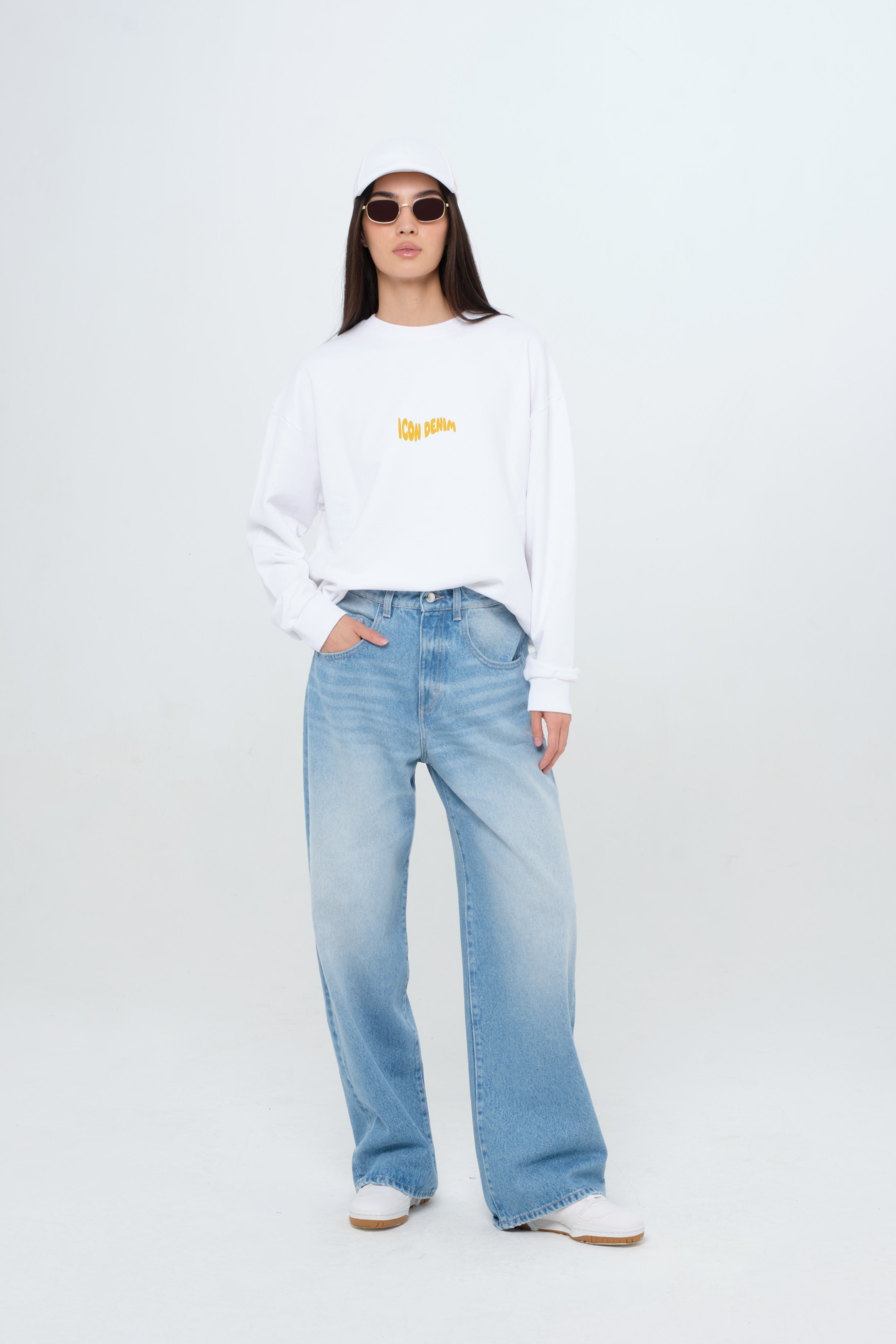 Poppy women’s wide leg jeans in medium wash, 100% rigid organic cotton denim, worn by a model with a white sweatshirt.
