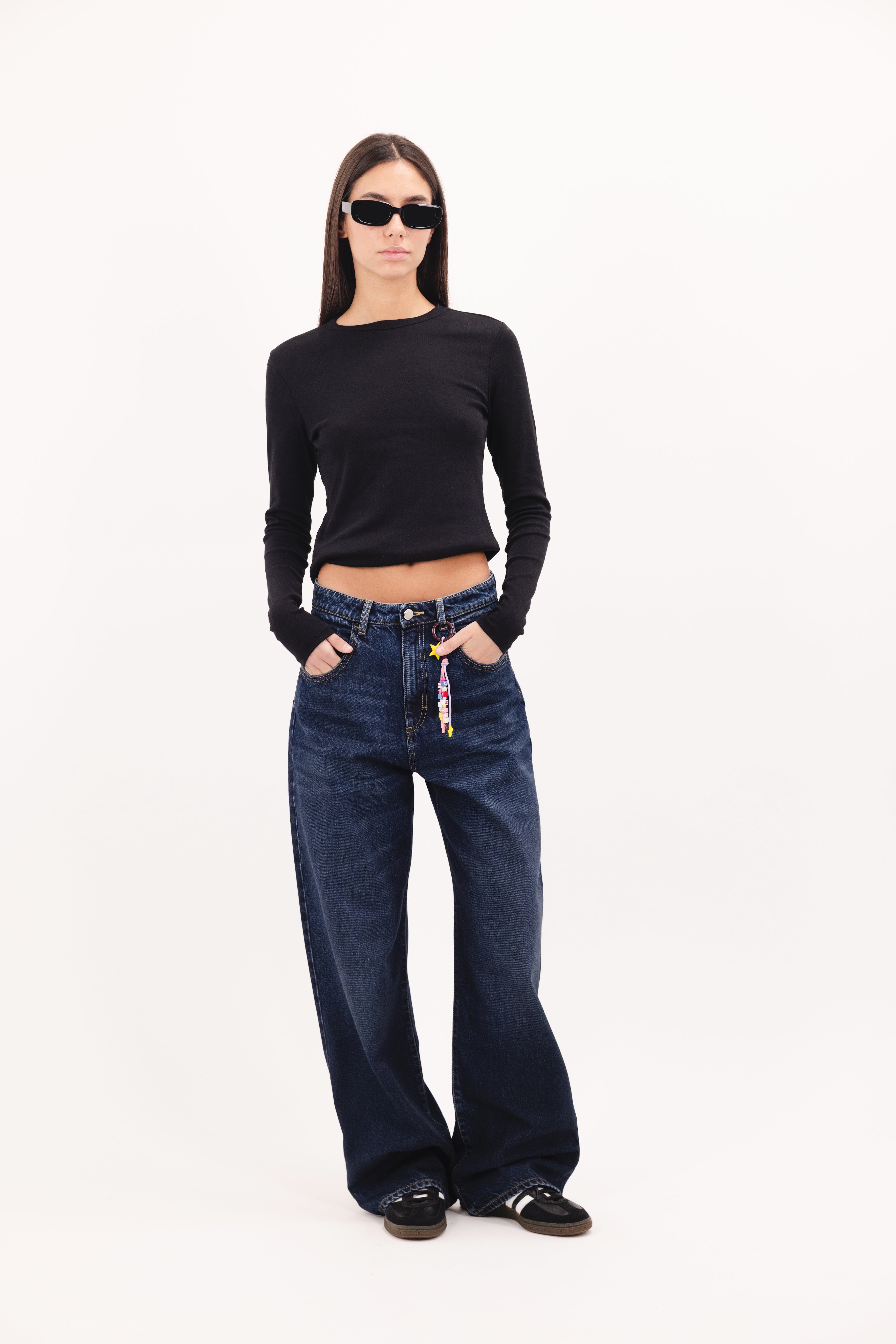 Poppy women’s wide leg jeans in dusty blue wash, 100% rigid cotton denim, worn by a model with a black top.