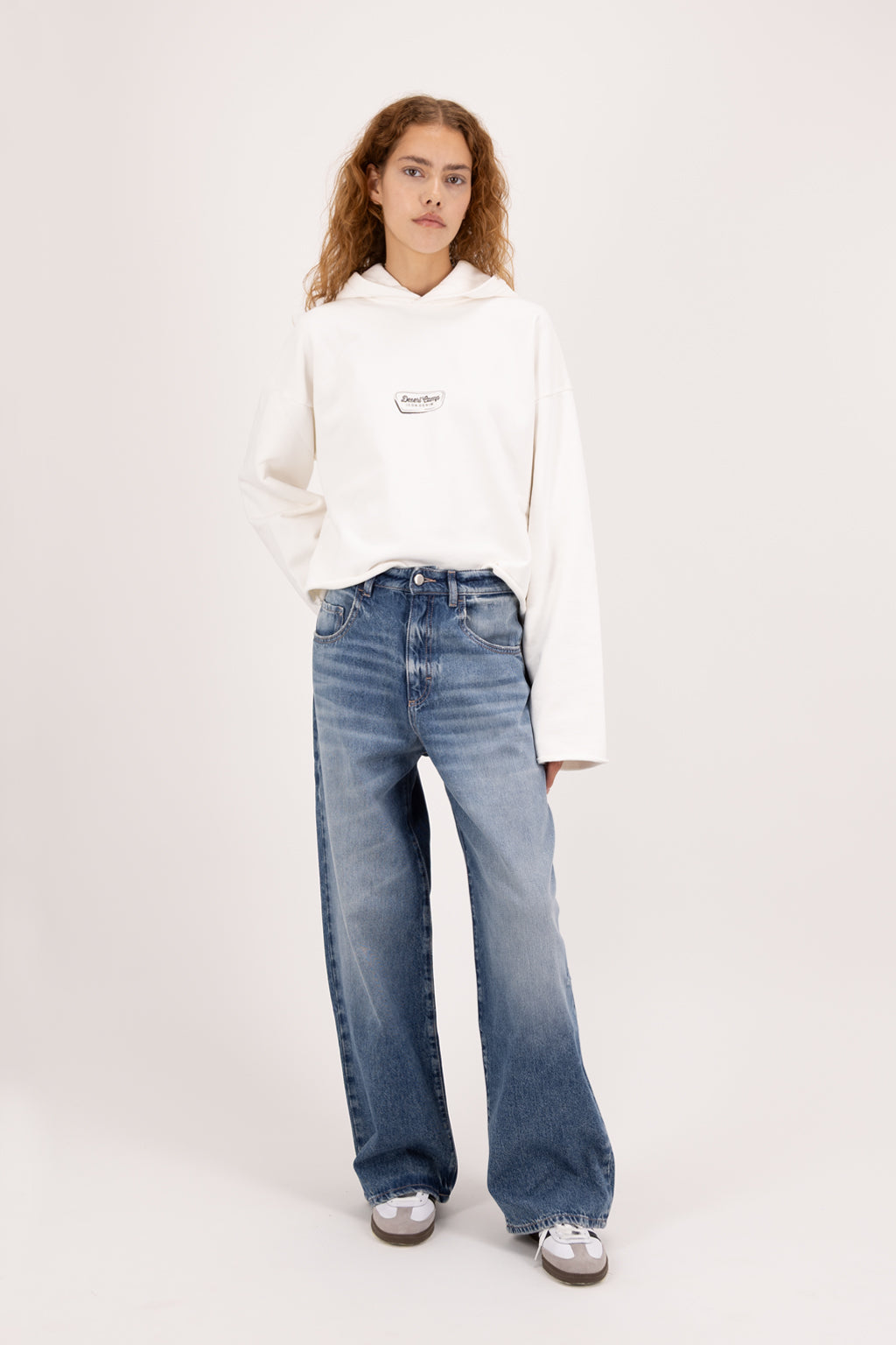 Poppy women’s wide leg jeans in eclipse wash, 100% rigid cotton denim, worn by a model with a white hoodie.
