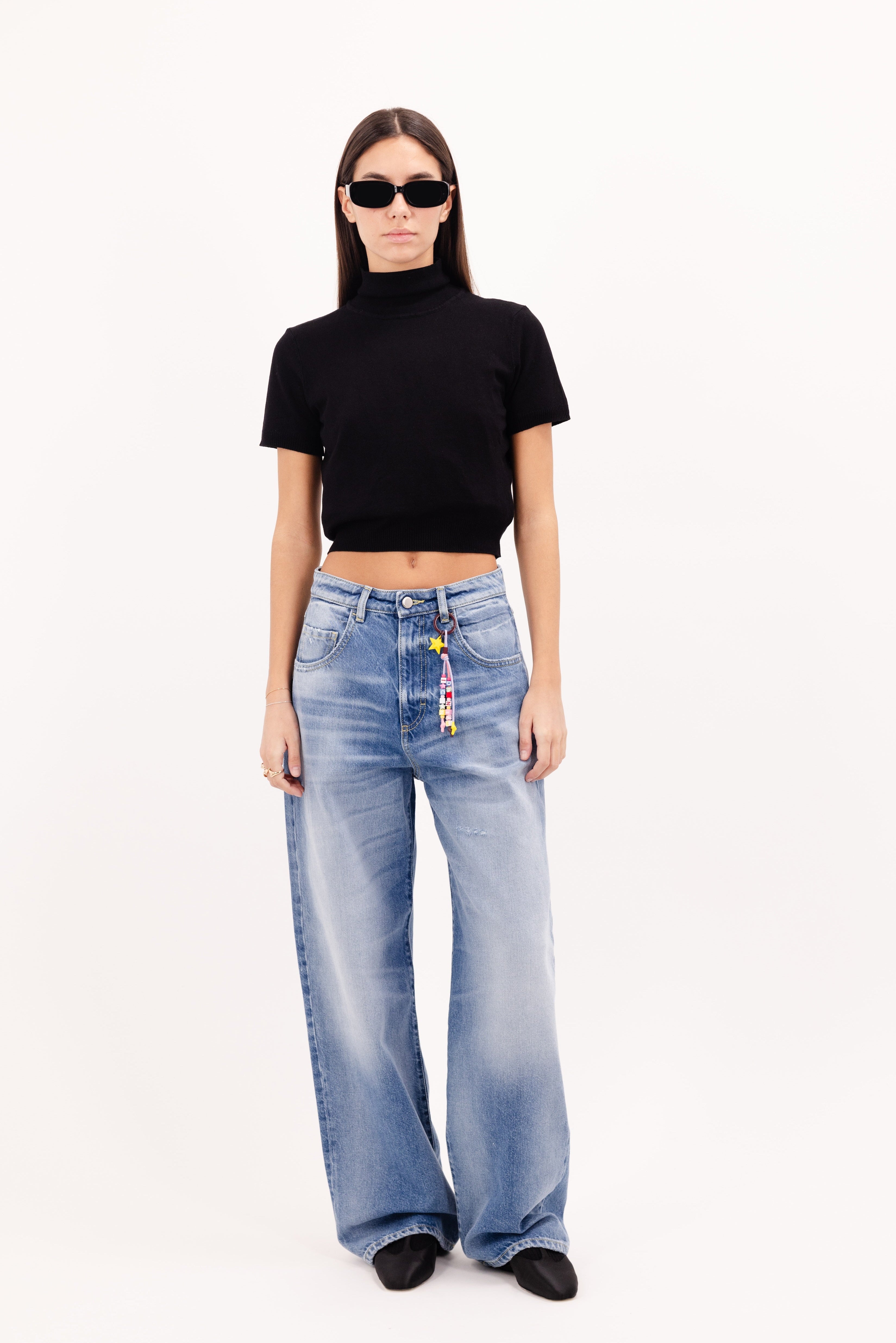Poppy women’s wide leg jeans in misty blue wash, 100% rigid cotton denim, worn by a model with a black top.