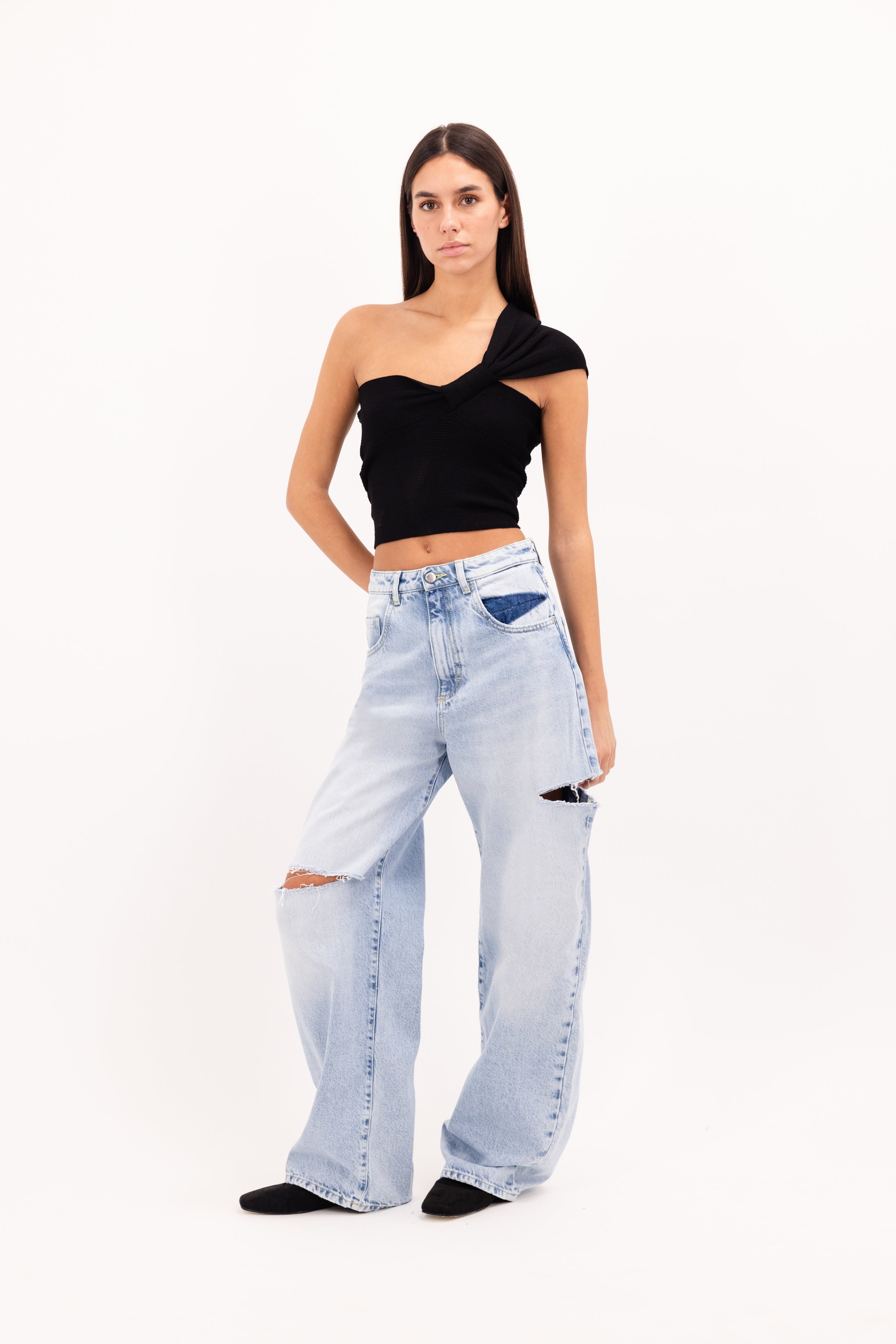 Poppy women’s wide leg jeans in sky blue wash, 100% rigid cotton denim, worn by a model with a black top.