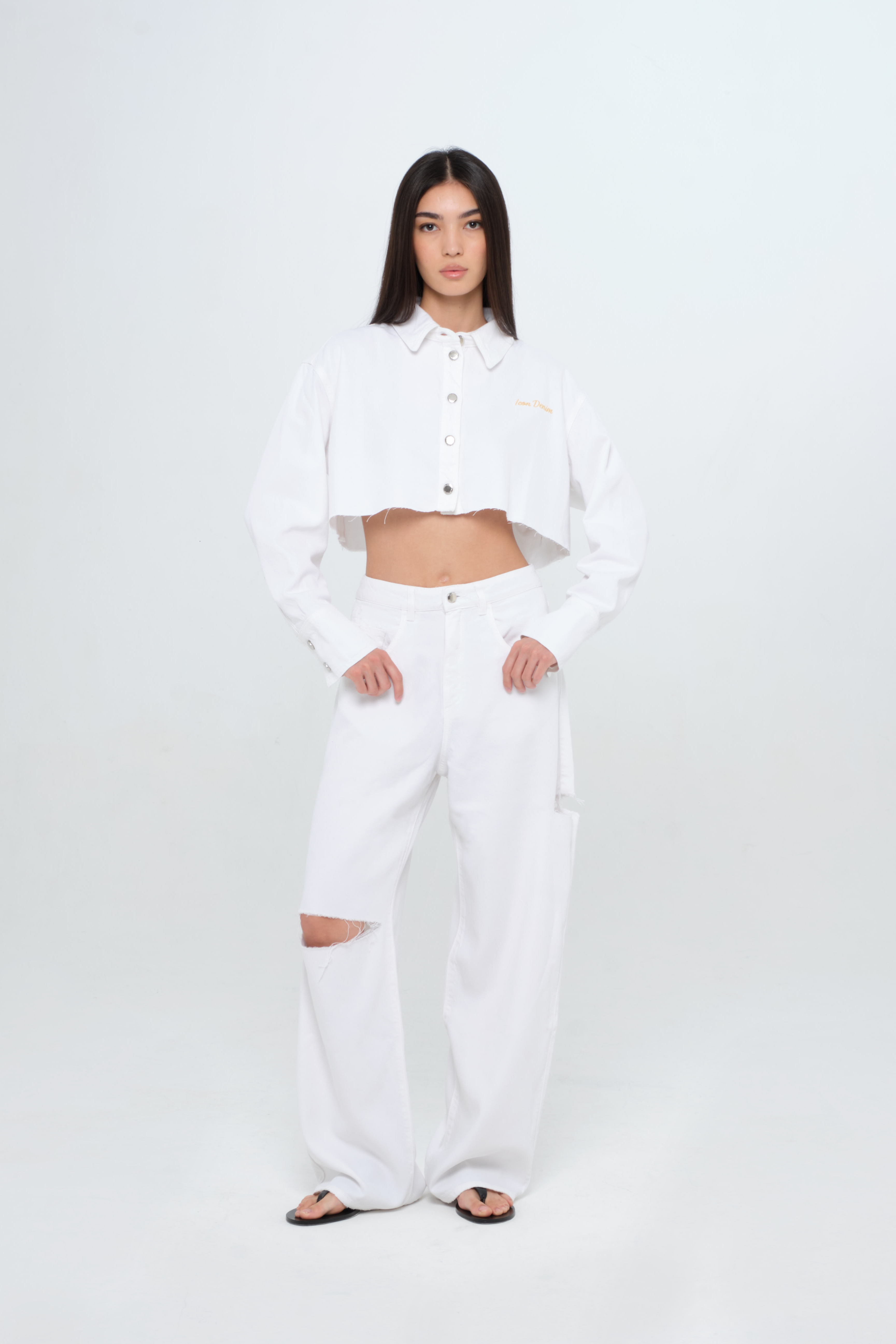 Poppy women’s wide leg jeans in white, 100% rigid soft cotton denim, worn by a model with a white denim shirt.