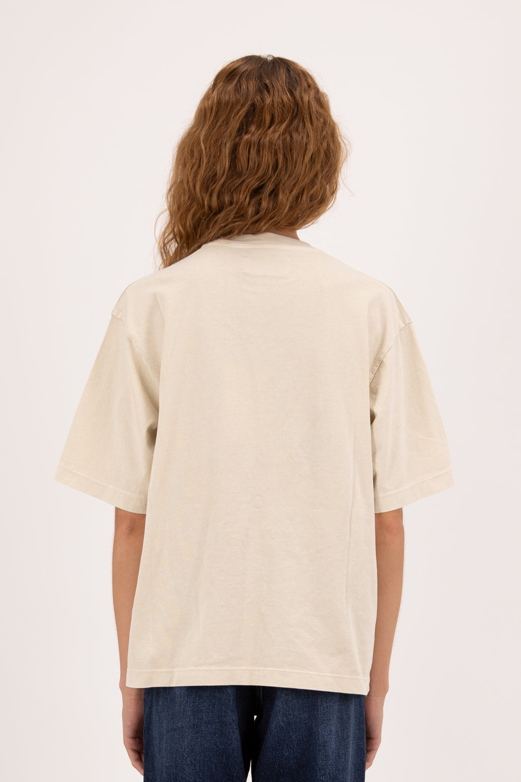 Back view of Sammy women’s t-shirt in desert, 100% cotton, worn by a model with jeans.
