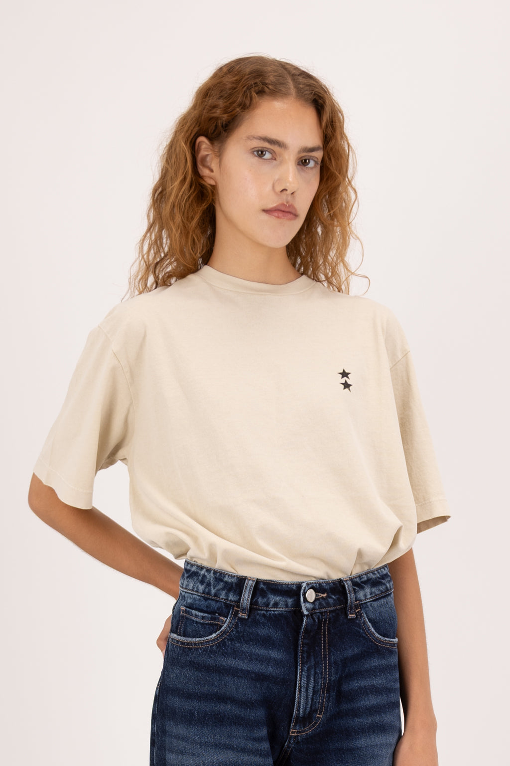 Sammy women’s t-shirt in desert, 100% cotton, worn by a model with jeans.
