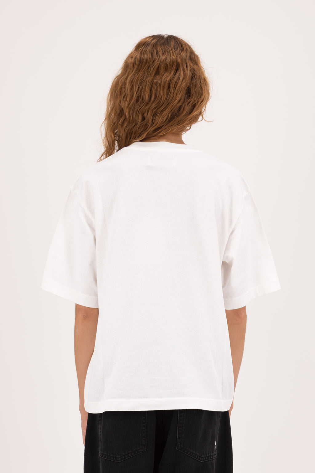 Back view of Sammy women’s t-shirt in white, 100% cotton, worn by a model with jeans.
