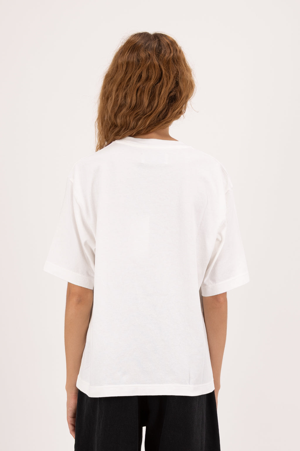 Back view of Sammy women’s t-shirt in white, 100% cotton, worn by a model with jeans.