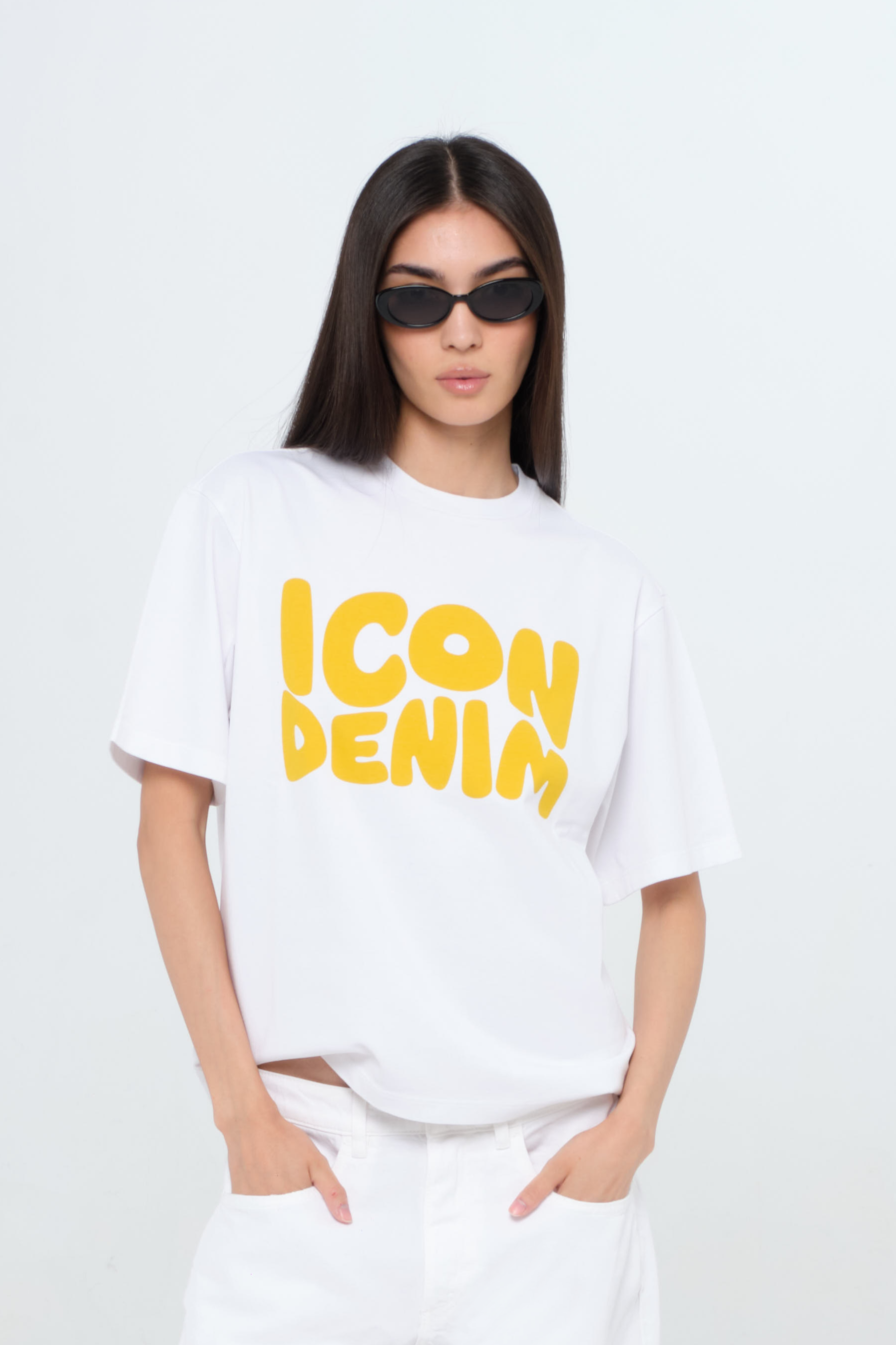 Sammy women’s t-shirt in white, 100% cotton, worn by a model with jeans.
