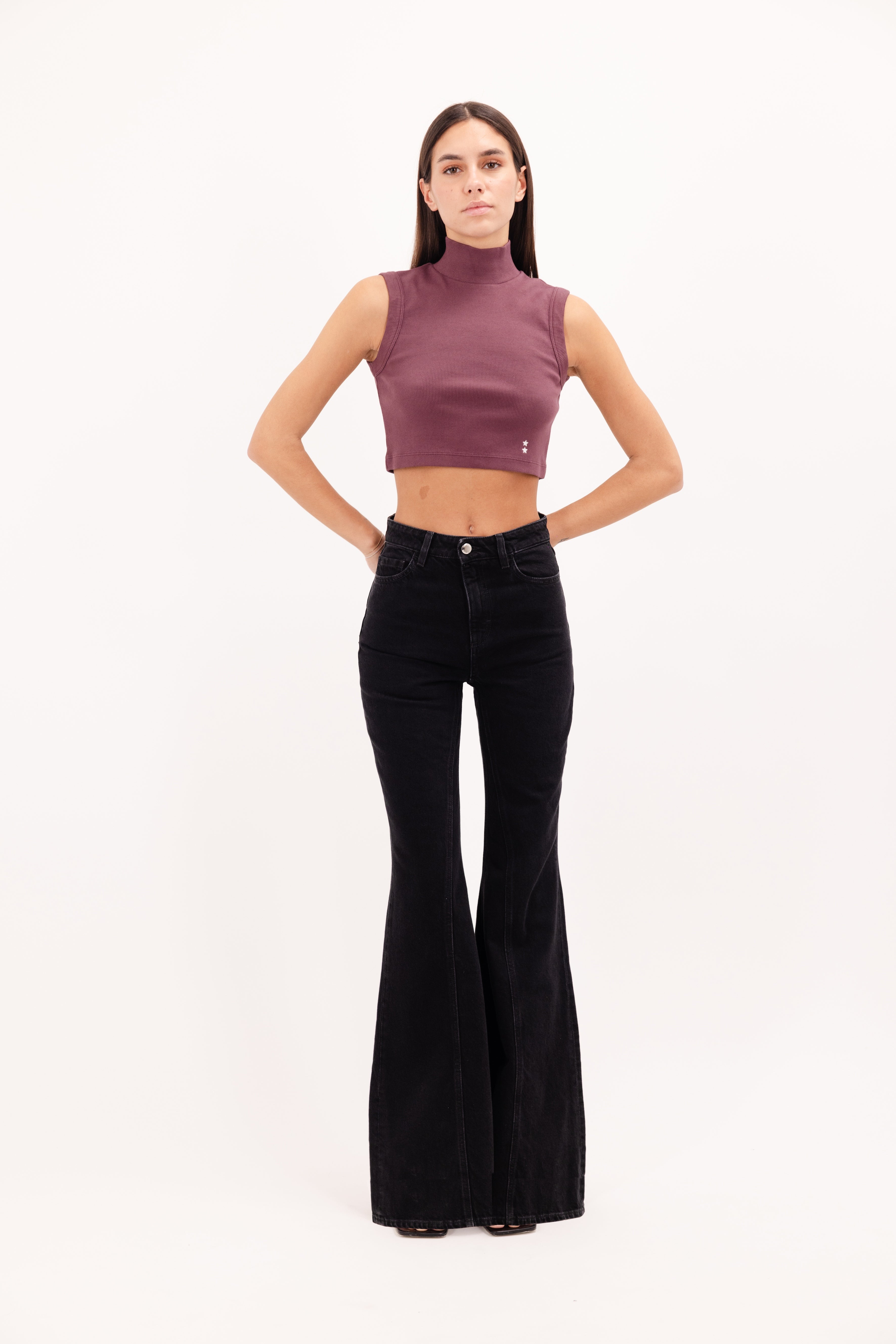 Stella women’s flared leg jeans in graphite black wash, 100% rigid cotton denim, worn by a model with a cherry top.