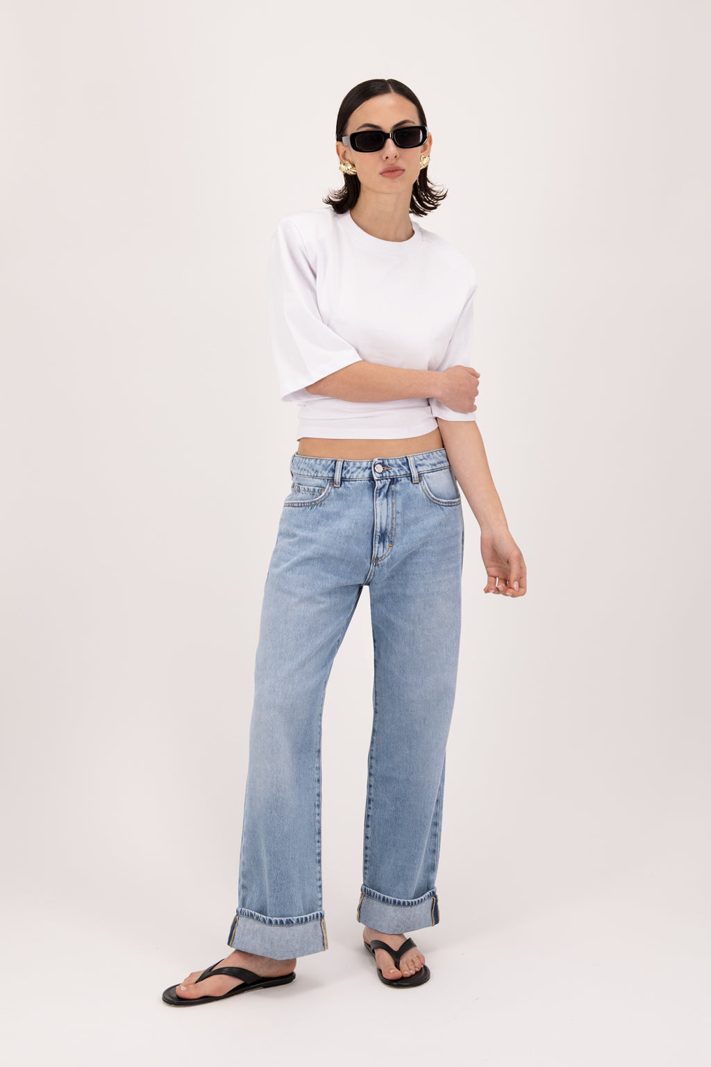 Tiny women’s wide leg cropped jeans in sky blue wash, 100% rigid soft cotton denim, worn by a model with a white t-shirt.