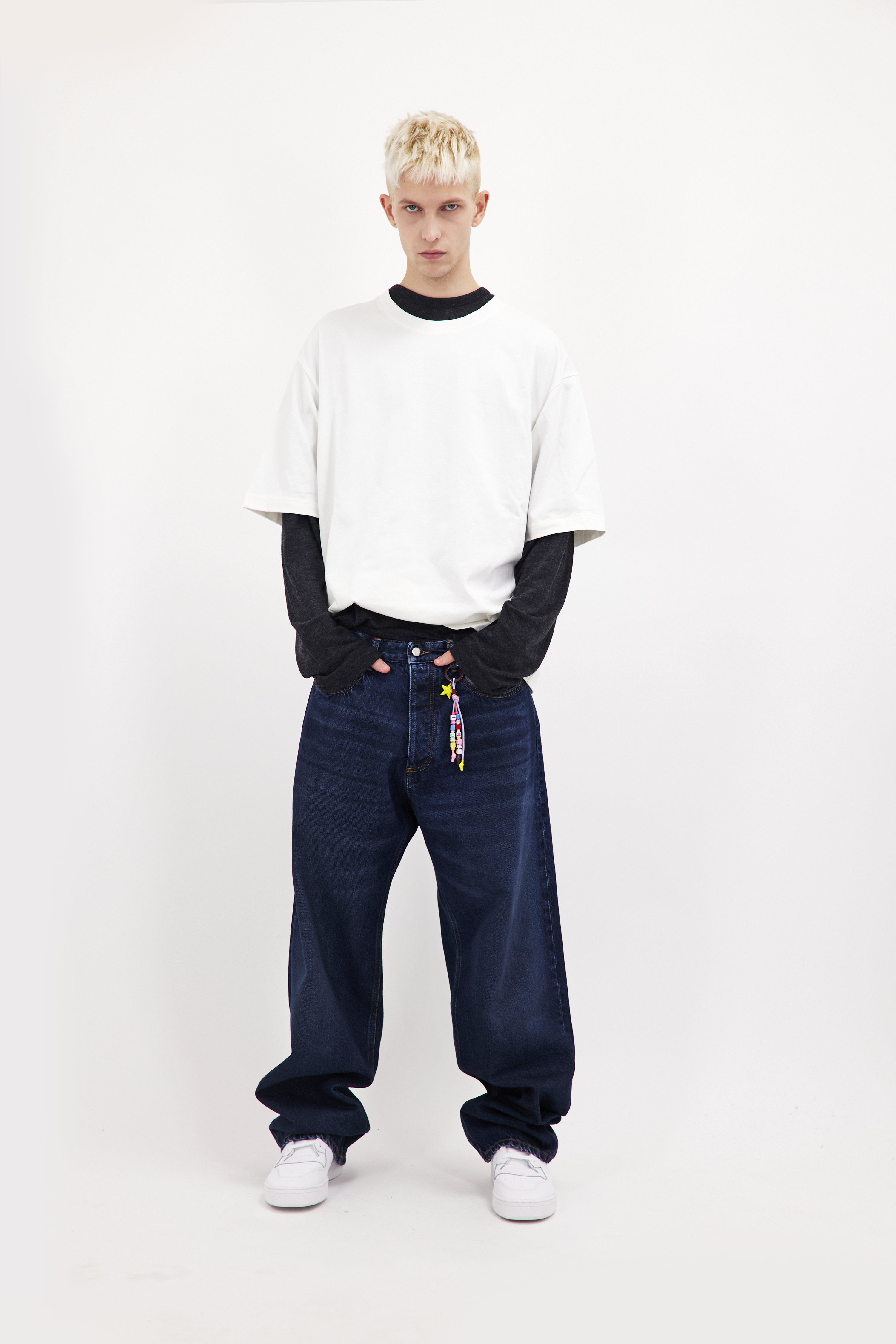 Will men’s wide leg jeans in dusty blue wash, 100% rigid cotton denim, worn by a model with a white t-shirt.