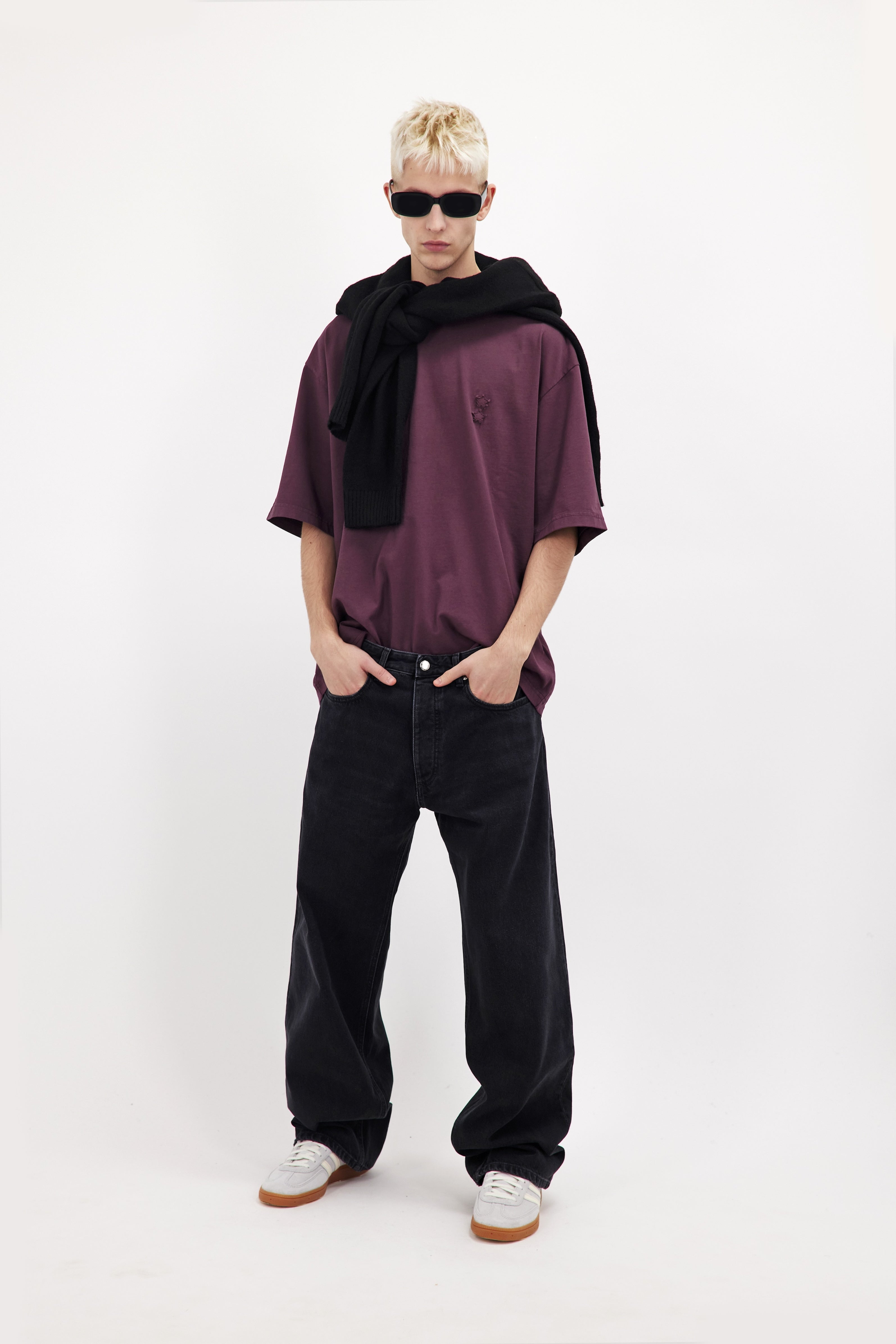 Will men’s wide leg jeans in graphite black wash, 100% rigid cotton denim, worn by a model with a cherry t-shirt.